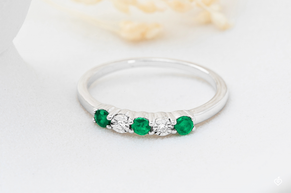 Alliance en or blanc avec 3 émeraude et 2 diamant sertis sur le haut de la bague